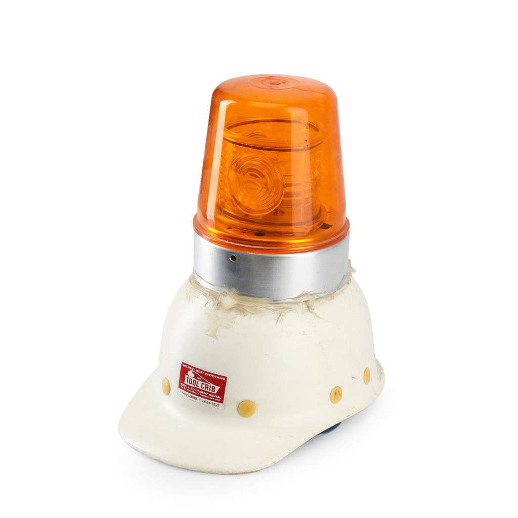 Orange Industrial Warning Light on White Hard Hat Base