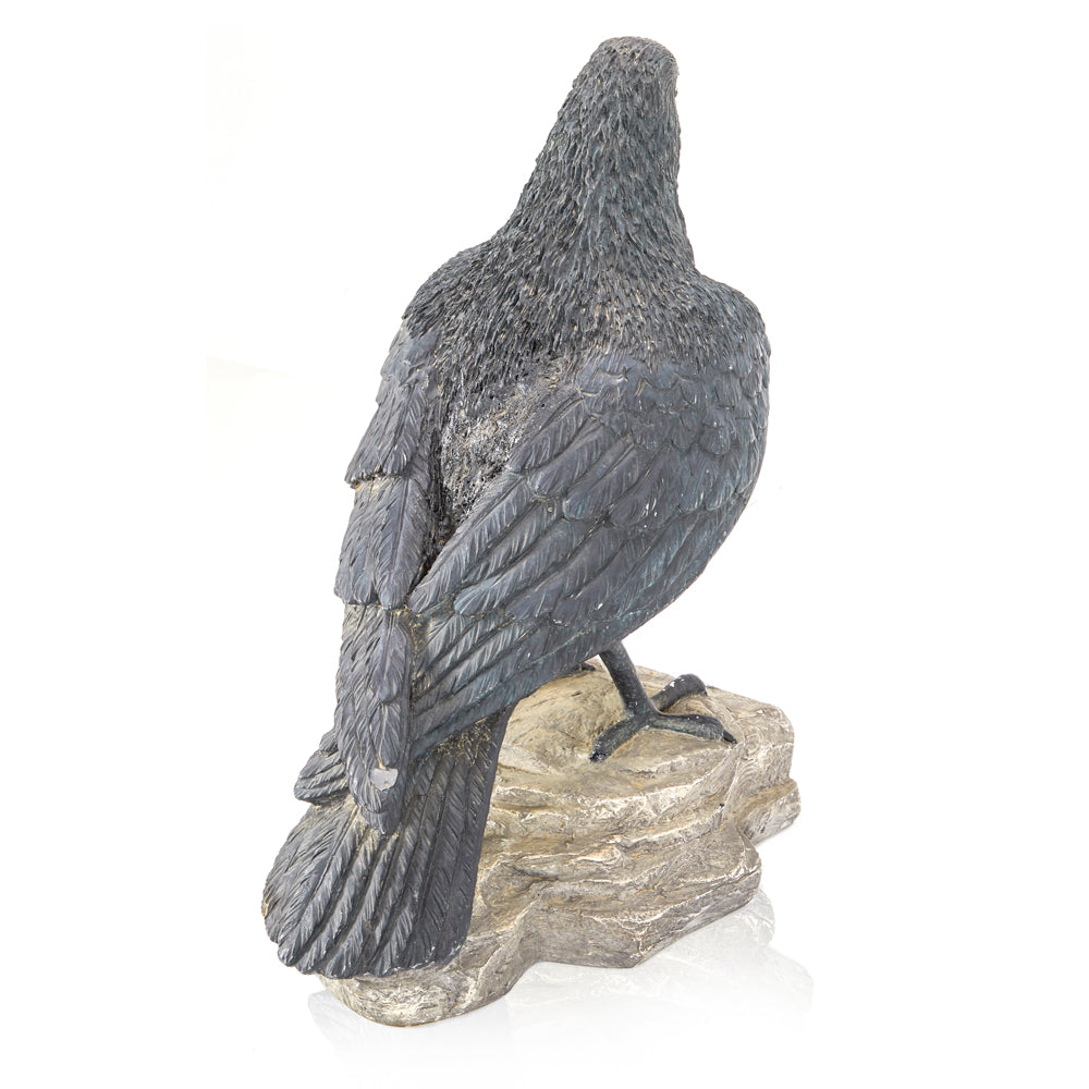 Crow Perched on Rock Sculpture