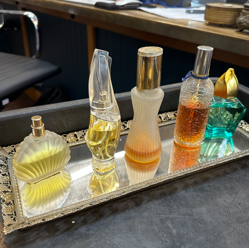 assorted perfume bottles with decorative tray